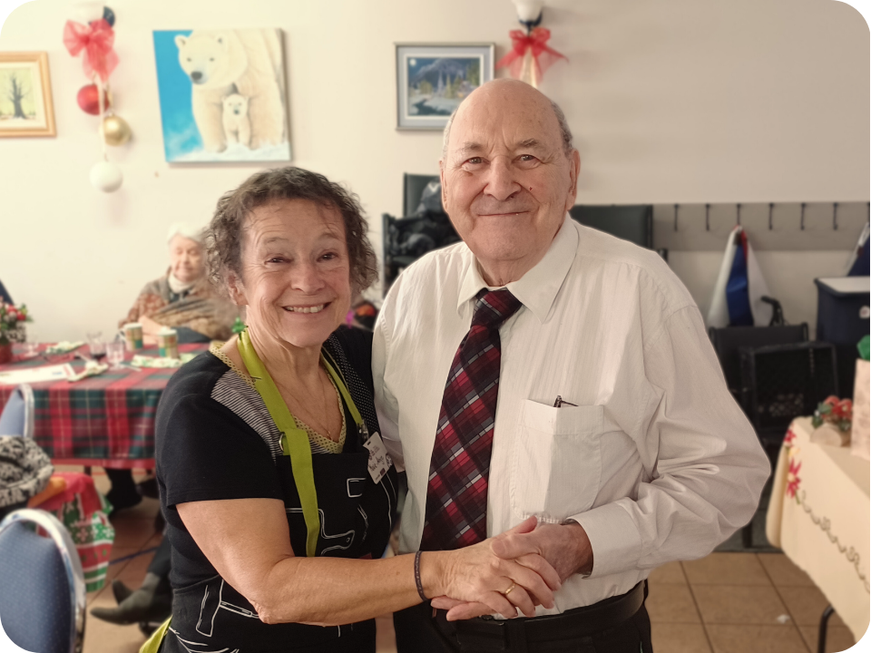 Une dame et un monsieur, main dans la main, avec un grand sourire aux lèvres